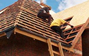 Two men installing a roof