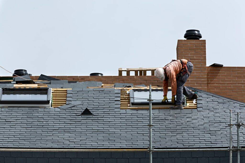 a roofer carrying out slate roof repairs